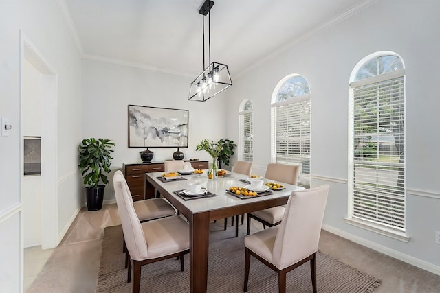 dining area with baseboards, a chandelier, and crown molding