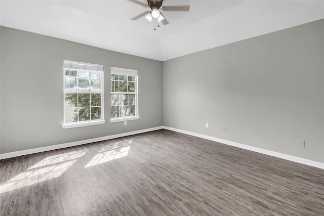 unfurnished room featuring ceiling fan, dark wood-style flooring, and baseboards