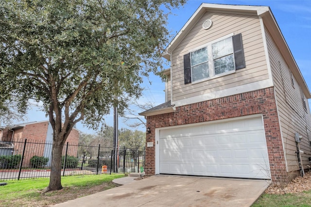 view of side of property with concrete driveway, brick siding, fence, and an attached garage