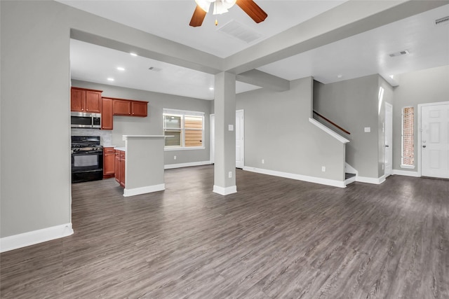 unfurnished living room with dark wood-style floors, stairs, and baseboards