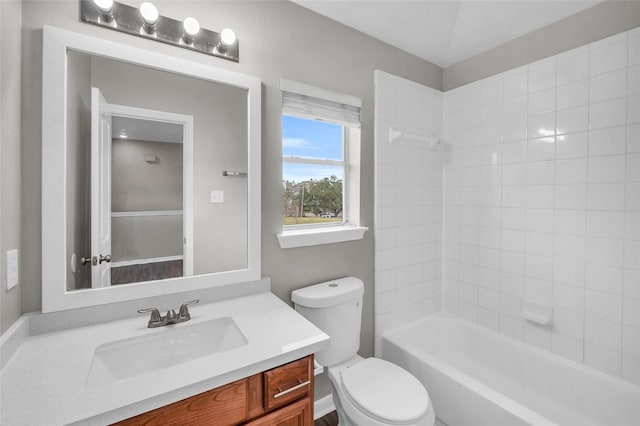 bathroom featuring toilet,  shower combination, and vanity