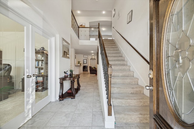 14510 Myers Dr, Houston, TX 77090 - entrance foyer featuring stairs, french doors, light tile patterned flooring, and a high ceiling