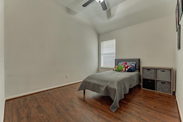 bedroom featuring ceiling fan, baseboards, vaulted ceiling, and wood finished floors