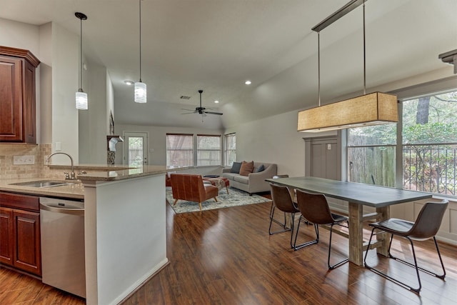 kitchen with dishwasher, dark wood-style floors, backsplash, pendant lighting, and a sink