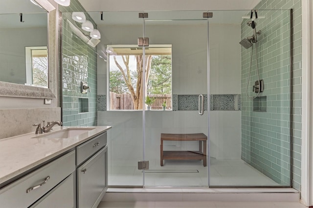 bathroom featuring a shower stall and vanity