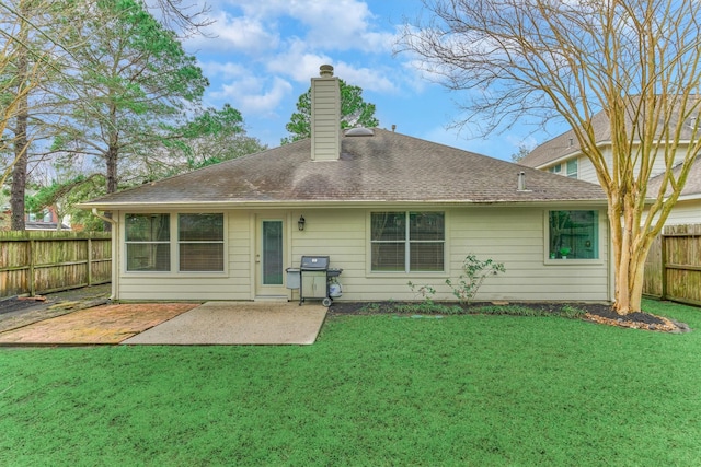 rear view of property with a patio area, a fenced backyard, a lawn, and a chimney