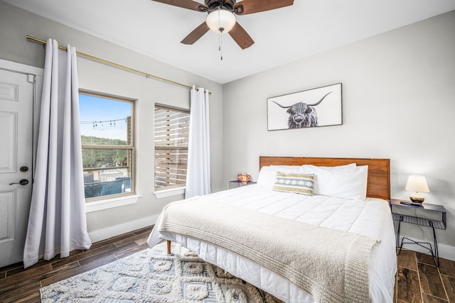 bedroom with baseboards, a ceiling fan, and wood finish floors