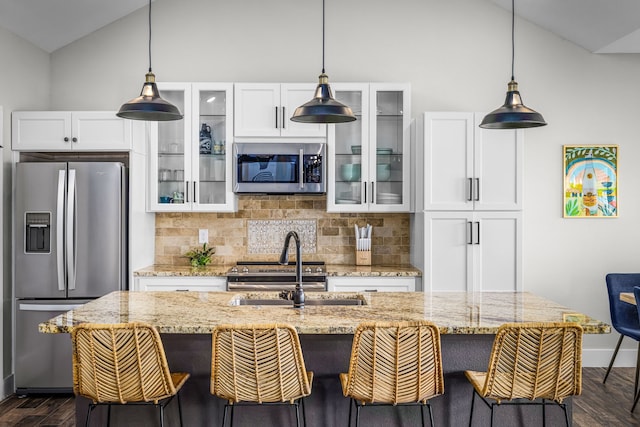 kitchen featuring appliances with stainless steel finishes, lofted ceiling, dark wood-style flooring, and tasteful backsplash