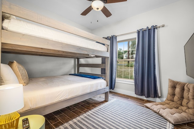 bedroom with wood tiled floor, ceiling fan, and baseboards