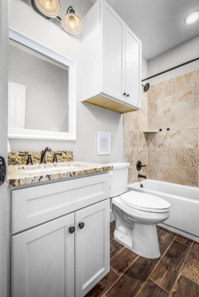 full bathroom featuring shower / bathing tub combination, vanity, toilet, and wood finished floors