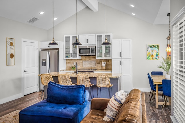 living area with visible vents, dark wood-type flooring, high vaulted ceiling, beamed ceiling, and baseboards