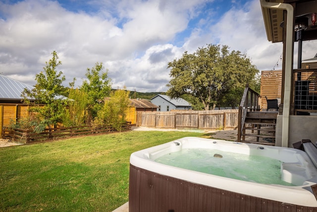 view of yard featuring stairway, fence, and a hot tub