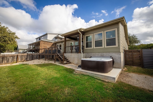 rear view of house with a deck, stairway, a lawn, and a fenced backyard