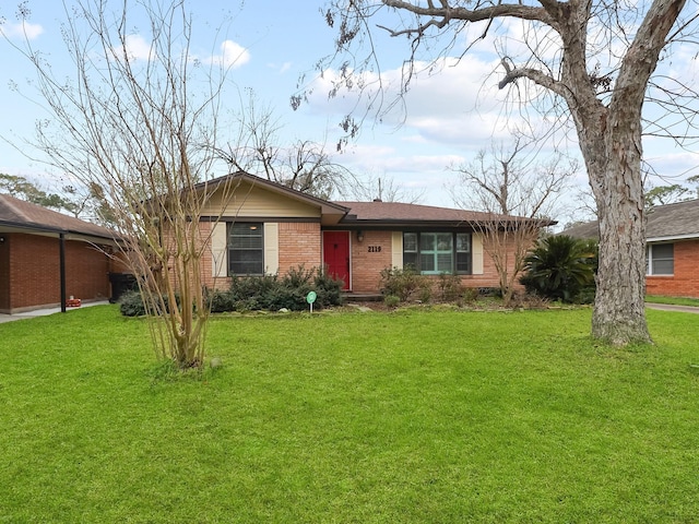 single story home with a front yard and brick siding