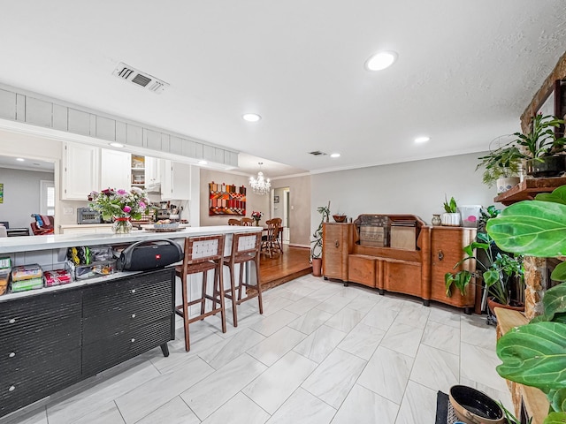 kitchen with light countertops, white cabinets, visible vents, and recessed lighting