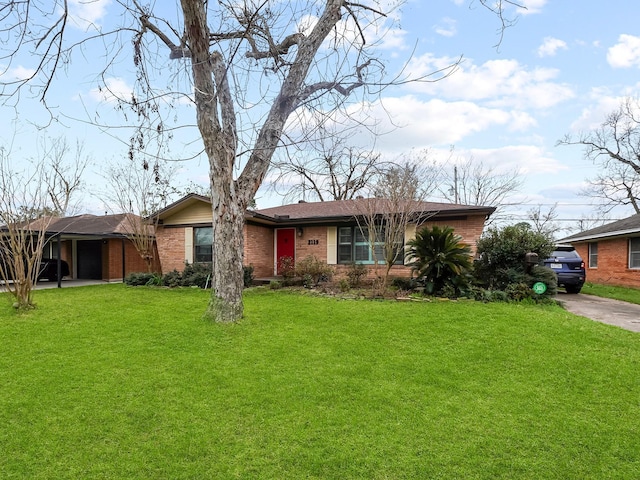 ranch-style home with driveway, a front lawn, and brick siding