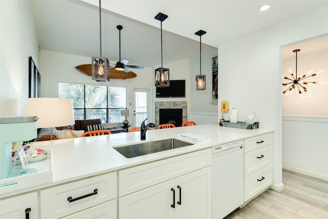 kitchen with open floor plan, light countertops, white dishwasher, and a sink