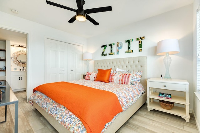 bedroom featuring a closet, ceiling fan, ensuite bath, and wood finished floors