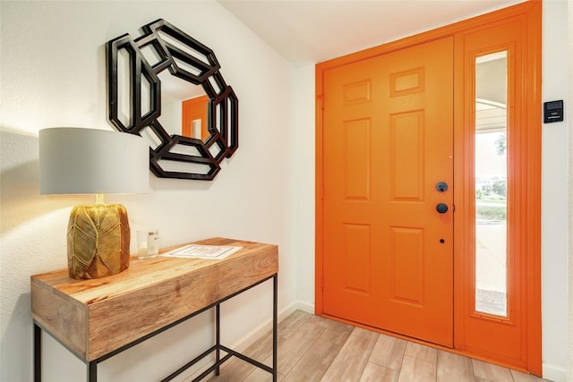 entrance foyer with light wood-style floors and baseboards