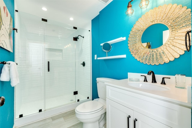 full bath with toilet, recessed lighting, visible vents, vanity, and a shower stall