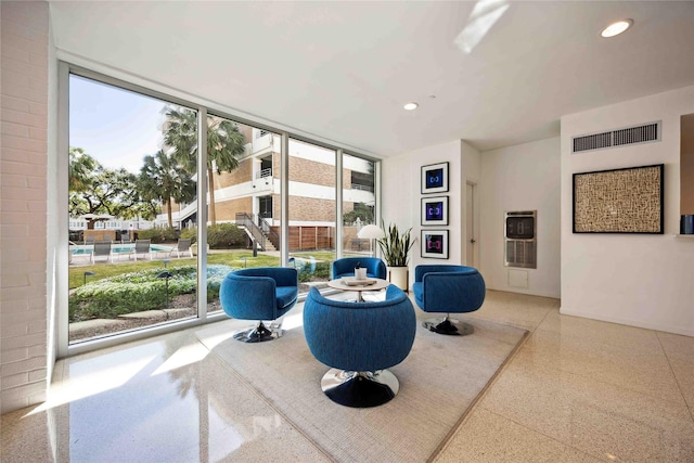 living area featuring visible vents, floor to ceiling windows, and recessed lighting