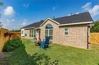 back of property featuring a fenced backyard and a yard