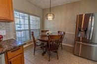 dining space with light tile patterned flooring and baseboards