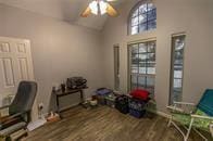 office area featuring lofted ceiling, ceiling fan, and wood finished floors