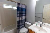 full bath featuring vanity, toilet, and shower / tub combo with curtain