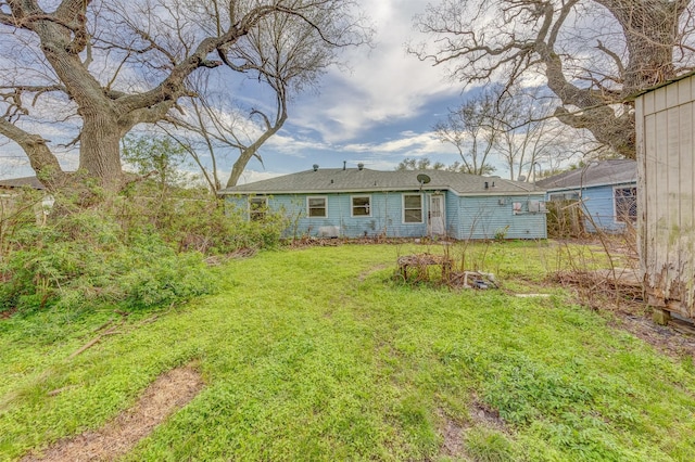 rear view of house with a yard