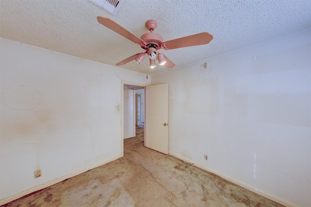 spare room with visible vents, baseboards, ceiling fan, a textured ceiling, and carpet floors