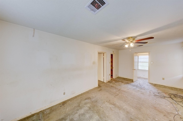 spare room featuring ceiling fan, visible vents, and baseboards