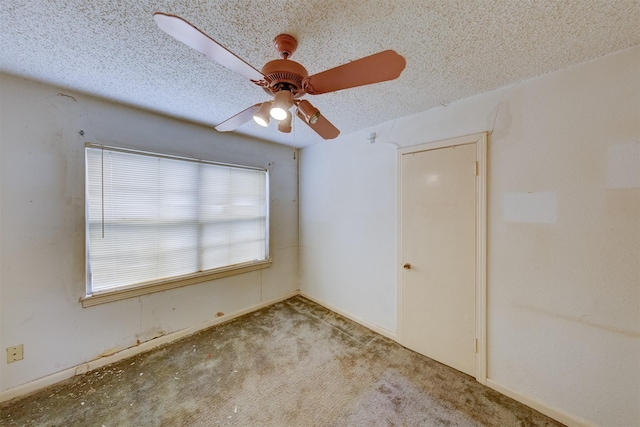 spare room featuring ceiling fan and a textured ceiling