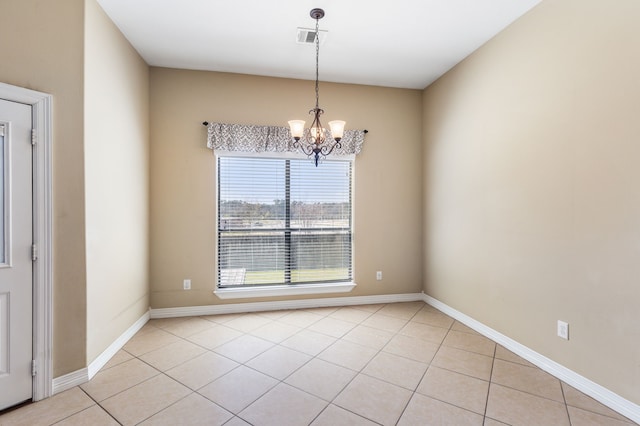 spare room featuring light tile patterned floors, a notable chandelier, baseboards, and visible vents