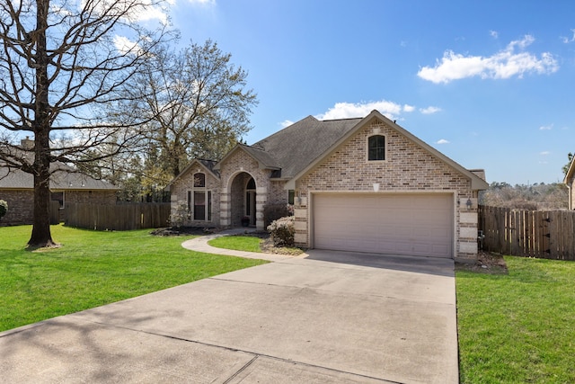 view of front of property featuring fence, concrete driveway, a front yard, a garage, and brick siding