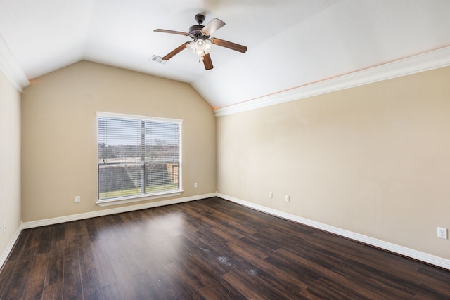 empty room featuring baseboards, visible vents, lofted ceiling, dark wood-style flooring, and ceiling fan