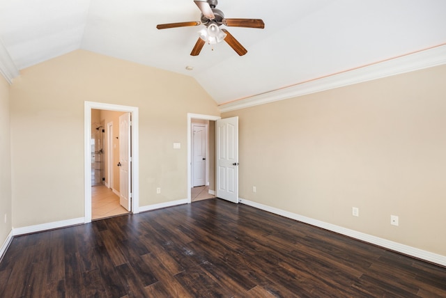 unfurnished bedroom with connected bathroom, ceiling fan, baseboards, vaulted ceiling, and wood finished floors