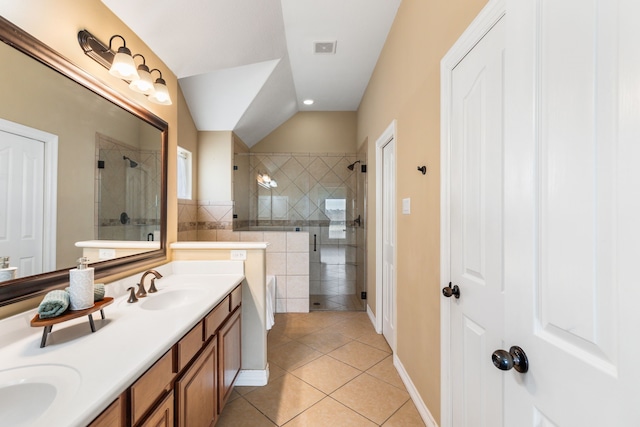 bathroom featuring visible vents, double vanity, a stall shower, a sink, and tile patterned floors