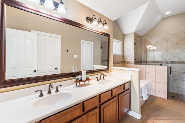 full bath featuring lofted ceiling, tile patterned floors, a shower stall, and a sink