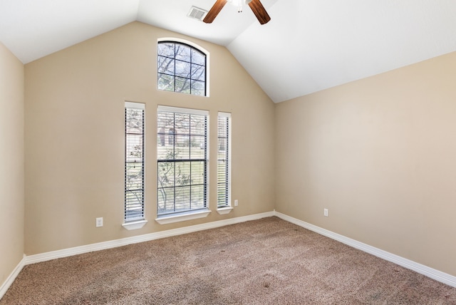 carpeted spare room with vaulted ceiling, a ceiling fan, visible vents, and baseboards