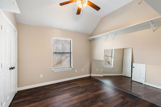 unfurnished bedroom with wood finished floors, a closet, baseboards, ceiling fan, and vaulted ceiling