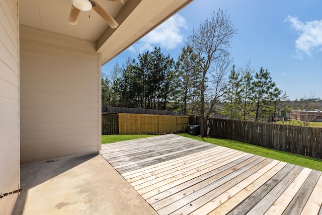 deck with a patio area, a fenced backyard, a lawn, and ceiling fan