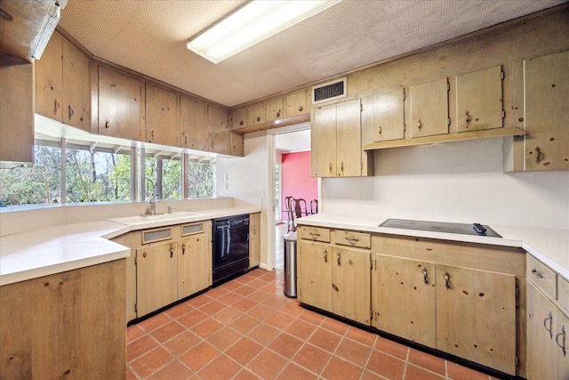 kitchen with light countertops, a sink, black appliances, and light tile patterned floors