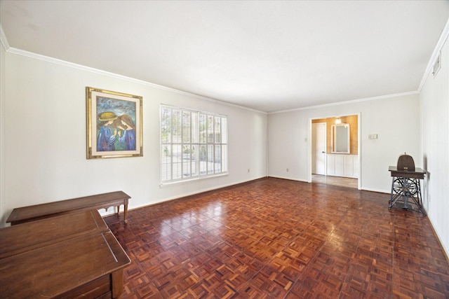 unfurnished living room with ornamental molding and baseboards