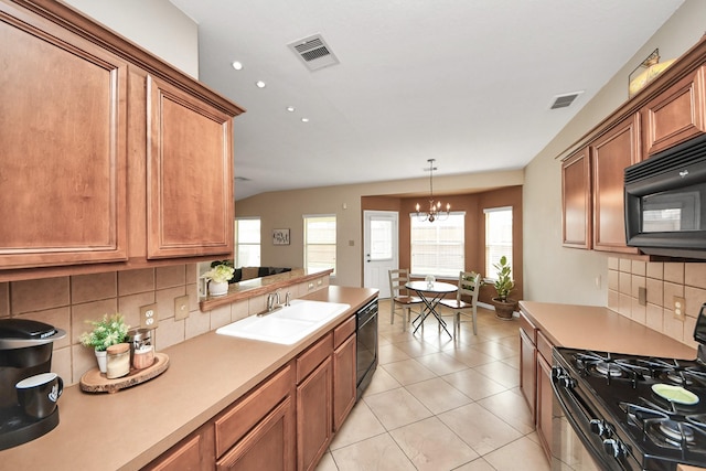 kitchen featuring light countertops, visible vents, a sink, and black appliances