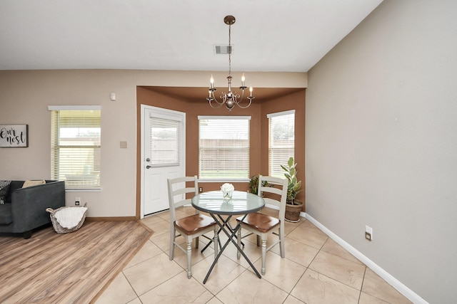 dining area with a notable chandelier, plenty of natural light, visible vents, and baseboards