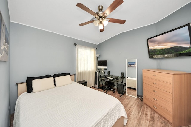 bedroom with light wood-type flooring, lofted ceiling, and a ceiling fan