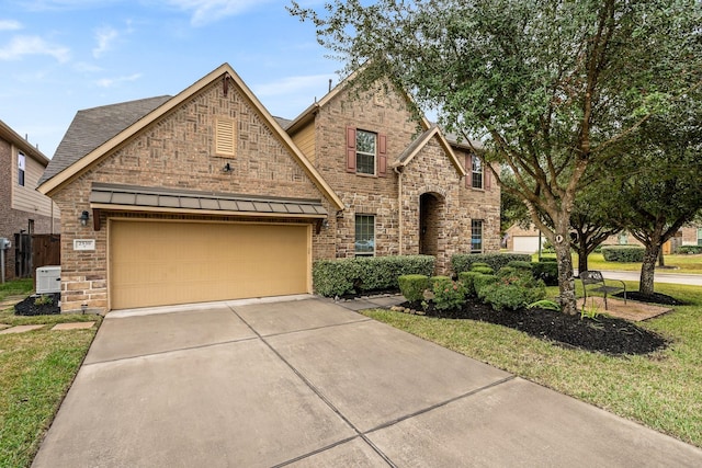 view of front of property featuring a garage, concrete driveway, and a front yard