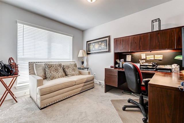 home office featuring light carpet and baseboards