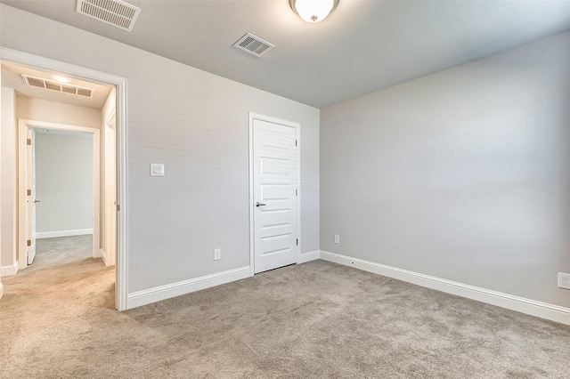 unfurnished bedroom with carpet floors and visible vents